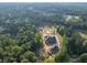 Panoramic aerial shot showcasing the home's generous lot size, surrounded by dense, mature trees and landscaping at 1730 Etchison Spur, Loganville, GA 30052