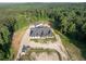 Aerial shot showcases the house, garage, and acreage in a lush forested setting at 1730 Etchison Spur, Loganville, GA 30052