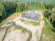 Aerial view of charming one story home with a large roof, detached garage and horse trails at 1730 Etchison Spur, Loganville, GA 30052
