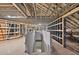 Unfinished attic space with exposed beams and insulation, offering potential for customization and additional living area at 1730 Etchison Spur, Loganville, GA 30052