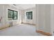 Spacious unfinished bedroom featuring large windows offering beautiful views of the outdoors at 1730 Etchison Spur, Loganville, GA 30052