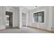 Spacious unfinished bedroom featuring a large window allowing ample natural light in at 1730 Etchison Spur, Loganville, GA 30052