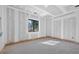 Spacious unfinished bedroom featuring natural light from the window and trim detail around the floors at 1730 Etchison Spur, Loganville, GA 30052