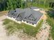 Exterior showing a modern home design with striking rooflines, set on a spacious lot with natural surroundings at 1730 Etchison Spur, Loganville, GA 30052
