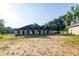 Spacious new construction home with a long driveway and archway entrance surrounded by natural beauty at 1730 Etchison Spur, Loganville, GA 30052