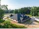 Exterior of the property showcasing architectural elegance and scenic beauty enhanced by surrounding mature trees at 1730 Etchison Spur, Loganville, GA 30052