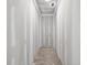 Narrow hallway with smooth grey concrete flooring and unpainted drywall walls at 1730 Etchison Spur, Loganville, GA 30052