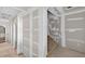 Hallway with arched doorways shows primed walls and wood staircase at 1730 Etchison Spur, Loganville, GA 30052