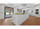 Large, bright kitchen with a center island, stylish floors, and white walls at 1730 Etchison Spur, Loganville, GA 30052