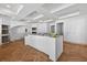 An expansive kitchen area with herringbone floors, large island, and recessed lighting at 1730 Etchison Spur, Loganville, GA 30052