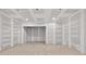 Unfinished living room ready to be decorated and personalized with concrete floors and drywall at 1730 Etchison Spur, Loganville, GA 30052