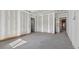 Large unfinished room featuring multiple doorways and trim detail around the floors at 1730 Etchison Spur, Loganville, GA 30052