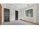 Bright, unfinished room has a window and two open doorways, ready to be custom designed at 1730 Etchison Spur, Loganville, GA 30052