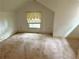 Bright attic space with a window, presenting a blank canvas for customization and renovation at 2641 Old Norcross Rd, Tucker, GA 30084
