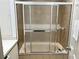 Bathroom featuring a bath and shower with sliding glass doors and tiled walls at 2641 Old Norcross Rd, Tucker, GA 30084