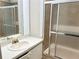 Bathroom featuring a single sink vanity and a shower and bath with sliding glass doors at 2641 Old Norcross Rd, Tucker, GA 30084