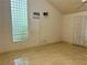 Bedroom with window featuring glass blocks, ceiling fan, and tiled flooring at 2641 Old Norcross Rd, Tucker, GA 30084