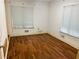 Bright bedroom with hardwood floors, natural light through two windows, and neutral walls providing comfort at 2641 Old Norcross Rd, Tucker, GA 30084