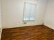 Simple bedroom with wood flooring, a window for natural light, and potential for personalization at 2641 Old Norcross Rd, Tucker, GA 30084