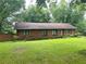 Ranch-style home featuring a brick facade, large yard and mature trees at 2641 Old Norcross Rd, Tucker, GA 30084
