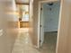 Hallway leading to the kitchen and rooms, featuring beige walls and tiled flooring at 2641 Old Norcross Rd, Tucker, GA 30084