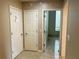 Hallway featuring beige walls and tiled flooring, with access to rooms via white doors at 2641 Old Norcross Rd, Tucker, GA 30084