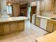 Spacious eat-in kitchen featuring an island, bright windows, and a red brick fireplace, enhancing character at 2641 Old Norcross Rd, Tucker, GA 30084