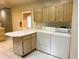Practical laundry area features a white countertop, washer, and dryer with convenient access to the kitchen at 2641 Old Norcross Rd, Tucker, GA 30084