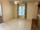 Inviting living room features tile floors, natural light, and a brick fireplace, creating a cozy atmosphere at 2641 Old Norcross Rd, Tucker, GA 30084