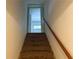 Carpeted staircase with a wooden handrail leading upstairs at 2641 Old Norcross Rd, Tucker, GA 30084