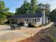Exterior of home featuring a patio with outdoor seating, a small deck, and a landscaped yard at 284 Regal Dr, Lawrenceville, GA 30046