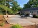 Spacious backyard patio area with a stone table set and lush landscaping at 284 Regal Dr, Lawrenceville, GA 30046