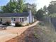 The backyard has a patio with an outdoor dining set, flowers, and a wooden fence at 284 Regal Dr, Lawrenceville, GA 30046