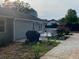 The back of the house has a patio area, a small deck, and leads to a lush backyard at 284 Regal Dr, Lawrenceville, GA 30046