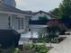 This backyard patio area includes a deck, garden beds, and a dark privacy fence at 284 Regal Dr, Lawrenceville, GA 30046