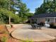 Exterior of home featuring a patio with outdoor seating, a small deck, and a landscaped yard at 284 Regal Dr, Lawrenceville, GA 30046