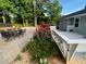 Backyard with dining and patio set is set off by gorgeous flowers and well-manicured lawn at 284 Regal Dr, Lawrenceville, GA 30046