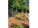 Yard featuring a landscaped flower bed, a wooden fence, and a concrete patio at 284 Regal Dr, Lawrenceville, GA 30046