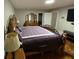 Bedroom showcases hardwood floors, a patterned bedspread, and a skylight for natural lighting at 284 Regal Dr, Lawrenceville, GA 30046