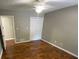 Comfortable bedroom featuring hardwood floors, neutral walls, and a ceiling fan at 284 Regal Dr, Lawrenceville, GA 30046