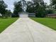 Home on a large lot featuring a spacious concrete driveway with an attached two car garage at 284 Regal Dr, Lawrenceville, GA 30046