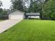 Well maintained home on a large lot featuring a sprawling green lawn, a driveway, and an attached two car garage at 284 Regal Dr, Lawrenceville, GA 30046