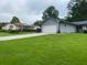 Quaint single story home on large lot with a sprawling green lawn and an extended concrete driveway at 284 Regal Dr, Lawrenceville, GA 30046