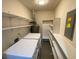 Practical laundry room featuring a washer, dryer, shelving, and ample storage at 284 Regal Dr, Lawrenceville, GA 30046