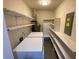 Convenient laundry room with washer, dryer, and ample shelving for storage and organization at 284 Regal Dr, Lawrenceville, GA 30046
