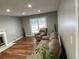 Bright living room featuring hardwood floors, neutral walls, and a cozy seating area by the windows at 284 Regal Dr, Lawrenceville, GA 30046