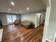 Welcoming living room with hardwood floors, comfortable seating, and access to an additional room at 284 Regal Dr, Lawrenceville, GA 30046
