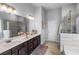 This bathroom features a double vanity, modern lighting, and a glass-enclosed shower at 3717 Blue Goose Ln, Loganville, GA 30052