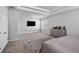 Spacious bedroom featuring a tray ceiling, grey walls, plush carpet, and a modern dresser at 3717 Blue Goose Ln, Loganville, GA 30052