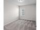 This bedroom features neutral carpet, a window, and crisp neutral paint at 3717 Blue Goose Ln, Loganville, GA 30052